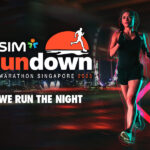 Beautiful Fitness Girl in Black Athletic Top and Shorts is Jogging on the Street. She is Doing a Workout in an Evening Wet Urban Environment Under a Bridge.